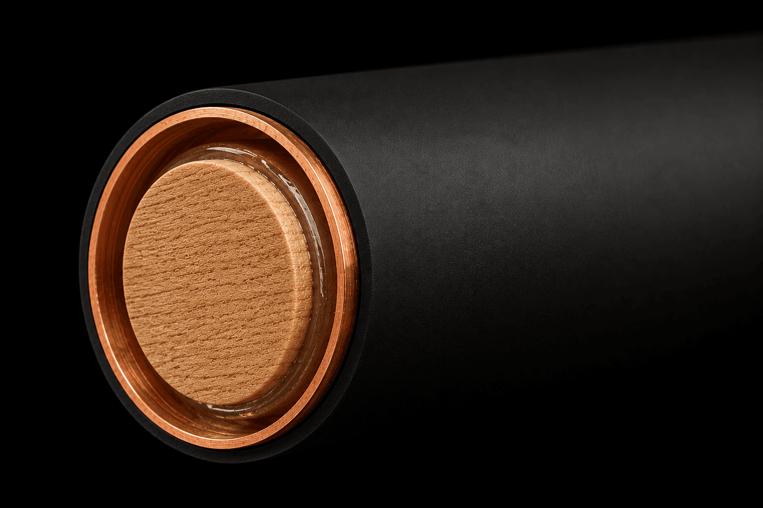 Cutaway of handle showing light hardwood dowel core epoxied inside a copper tube with fine bump black silicone grip wrap